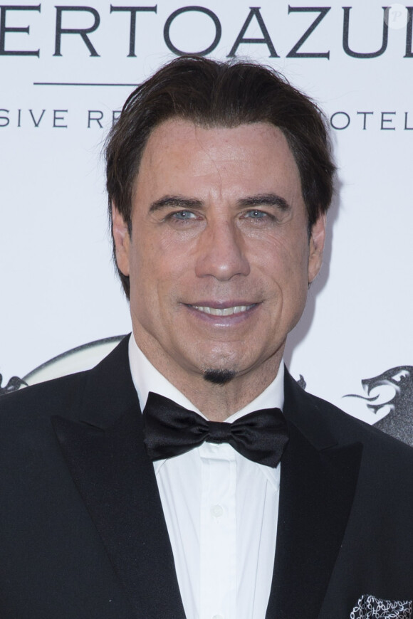 John Travolta - Photocall de la soirée "Puerto Azul Experience" lors du 67ème festival de Cannes le 21 mai 2014.