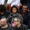 Marcel Desailly et ses enfants pendant le match entre Jo-Wilfried Tsonga et Jürgen Melzer à Roland-Garros à Paris, le 28 mai 2014. 