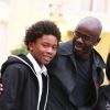 Lilian Thuram et son fils Khephren après avoir été élevé au grade d'Officier de la Légion d'honneur par le président de la République François Hollande au palais de l'Elysée à Paris le 17 septembre 2013