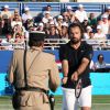 Henri Leconte et le gendarme de Saint-Tropez lors du Classic Tennis Tour à Saint-Tropez, le 12 juillet 2014.