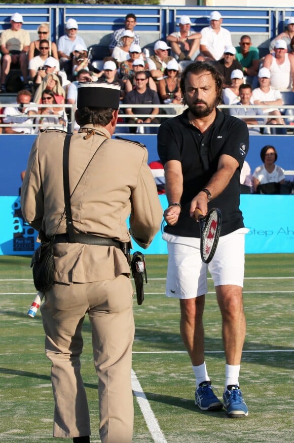 Henri Leconte et le gendarme de Saint-Tropez lors du Classic Tennis Tour à Saint-Tropez, le 12 juillet 2014.