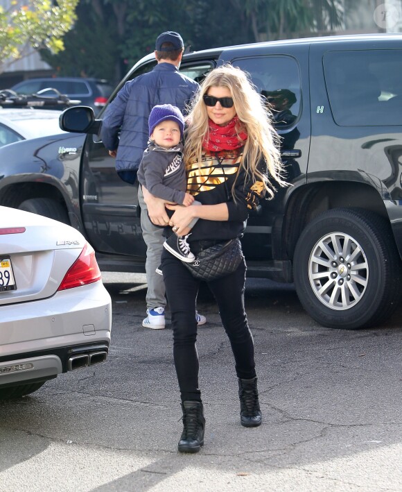 Josh Duhamel et sa femme Fergie se promènent avec leur fils Axl à Los Angeles, le 20 décembre 2014. 
