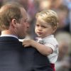Le prince William et son fils le prince George de Cambridge lors du baptême de la princesse Charlotte en l'église Saint Mary Magdalene de Sandringham, le 5 juillet 2015