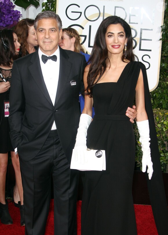 George Clooney et sa femme Amal Alamuddin Clooney (robe Dior Haute Couture) - "Je suis Charlie" à la 72ème cérémonie annuelle des Golden Globe Awards à Beverly Hills, le 11 janvier 2015.