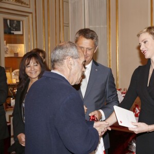 La princesse Charlene a distribué avec le prince Albert II de Monaco, le 17 novembre 2015, à l'avant-veille de la Fête nationale, des colis de la Croix-Rouge monegasque aux personnes âgées à Monaco le 17 novembre 2015. En prime cette année, une photo du couple princier posant avec ses enfants le prince héréditaire Jacques et la princesse Gabriella. © Jean-Charles Vinaj / Pool restreint / Bestimage