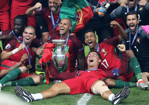 Cristiano Ronaldo vainqueur de l'EURO 2016, pose avec ses coéquipiers et le trophée.