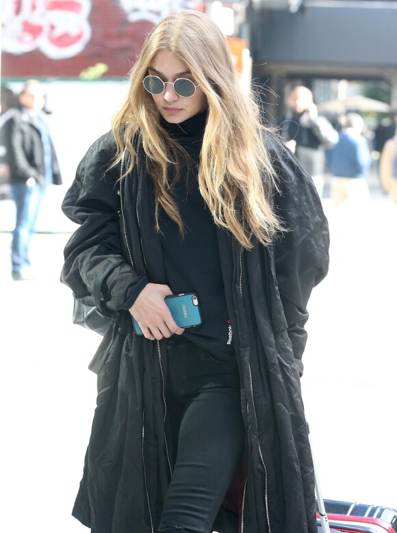 Gigi Hadid is spotted wheeling her luggage in NYC. The supermodel warms up in an oversized jacket as she flashes a small smile to the cameras. She grips her phone tight while making her way to her destination after wishing sister Bella Hadid congratulations on her achievement of being the newest Victoria's Secret angel, New York City, NY, USA on October 26, 2016. Photo by AKM-GSI/ABACAPRESS.COM27/10/2016 - New York City