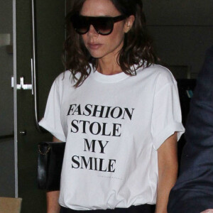 Victoria Beckham porte un t-shirt de sa collection Victoria by Victoria Beckham avec le slogan 'Fashion Stole My Smile' à son arrivée à l'aéroport de LAX à Los Angeles, le 28 mars 2017 © CPA/Bestimage