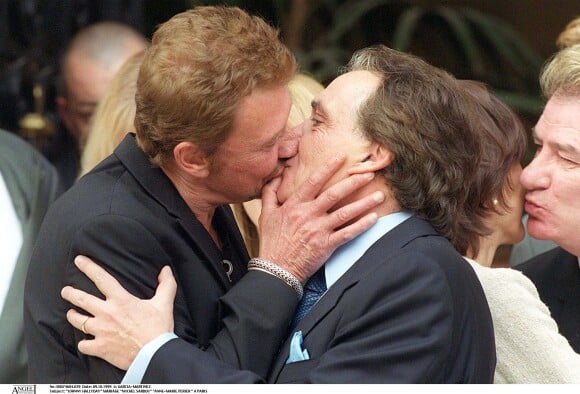 Johnny Hallyday embrasse Michel Sardou en 1999