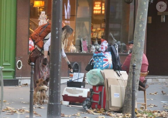 Exclusif - Paris Jackson donnant une pièce de monnaie à une personne sans-abri à Paris le 22 novembre 2017. Elle s'est ensuite approchée du chien pour lui donner une caresse.
