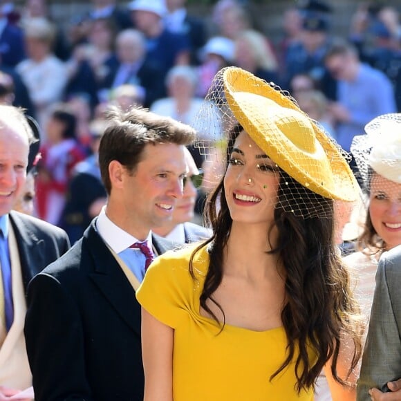 George Clooney et sa femme Amal arrivent à la chapelle S. George pour le mariage du prince Harry et de Meghan Markle au château de Windsor, Royaume Uni, le 19 mai 2018.