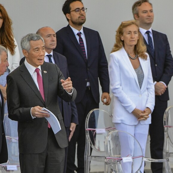 Gérard Collomb, Lee Hsien Loong, Mounir Mahjoubi, Nicole Belloubet, Jean-Baptiste Lemoyne, Jacques Mézard, Delphine Gény-Stephann, Bruno Le Maire, Brigitte et Emmanuel Macron, Muriel Pénicaud, Edouard Philippe - Défilé militaire du 14 Juillet sur les Champs-Elysées à Paris © Pierre Perusseau / Bestimage