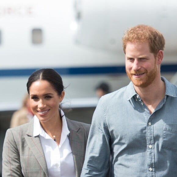 Le prince Harry, duc de Sussex, et Meghan Markle (enceinte), duchesse de Sussex, à leur arrivée à l'aéroport de Dubbo, à l'occasion de leur voyage officiel en Australie. Le 17 octobre 2018.