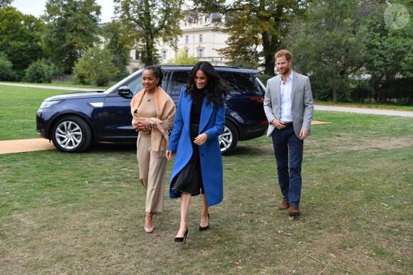Meghan Markle, duchesse de Sussex, portant une jupe Misha Nonoo et accompagnée par sa mère Doria Ragland et son mari le prince Harry, lors de la réception au palais de Kensington le 20 septembre 2018 des femmes d'une cuisine communautaire qu'elle avait rencontrées auparavant.