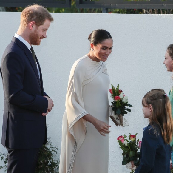 Le prince Harry, duc de Sussex, et Meghan Markle, duchesse de Sussex, enceinte assistent à une réception organisée par l'ambassadeur britannique au Maroc, à la résidence britannique de Rabat, le 24 février 2019.