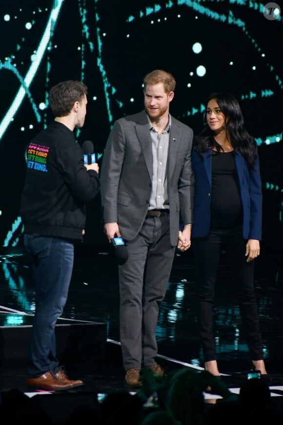 Le prince Harry, duc de Sussex, et Meghan Markle, duchesse de Sussex, enceinte, lors de l'évènement WE Day au Wembley Arena à Londres, Royaume Uni, le 6 mars 2019.