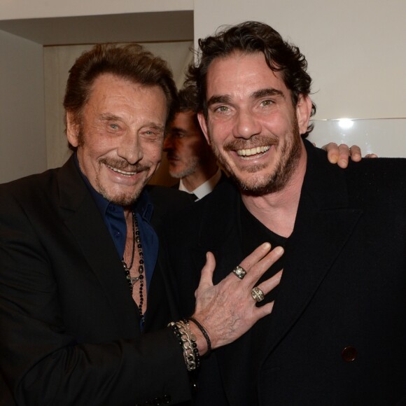 Johnny Hallyday et Sébastien Farran lors d'un événement chez Montaigne Market à Paris le 4 mars 2016.