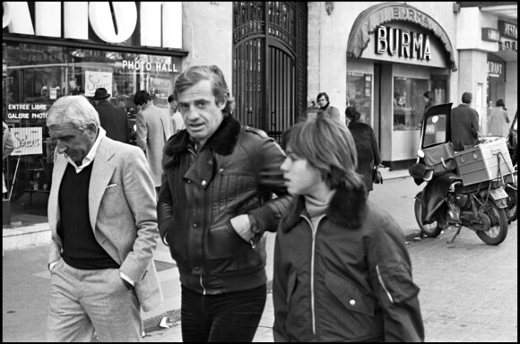 Archives - Jean-Paul Belmondo avec son fils Paul et Charles Gérard sur les Champs-Elysées de Paris. Le 4 février 1977.