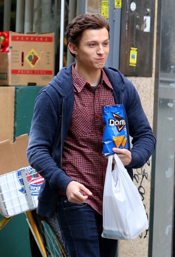 Tom Holland sur le tournage du film "Spider-Man : Far From Home" à Brooklyn, New York, le 16 octobre 2018. Il mange un paquet de chips.