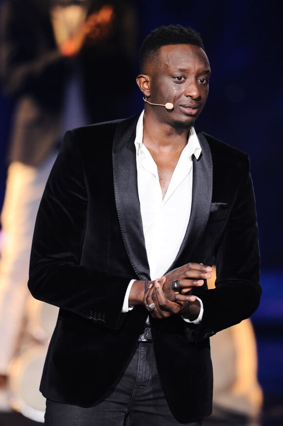 Exclusif - Ahmed Sylla - Enregistrement de l'émission TV "La Chanson Secrète 3", qui sera diffusée le vendredi 1er novembre à 21h00 sur TF1. Après le succès de la première édition, "La Chanson Secrète", présentée par N.Aliagas et produite par DMLS TV, revient sur TF1. 10 artistes ne savent rien de ce qui va se passer pour eux ! Ils ont accepté de jouer le jeu, de se laisser totalement surprendre, émouvoir, parfois même déstabiliser car ils vont découvrir en même temps que les téléspectateurs une surprise : une chanson qui leur rappelle un souvenir important de leur vie revisitée et réinterprétée par un artiste. Les téléspectateurs seront aux premières loges pour vivre ces moments d'intimité musicale rare. Et, en bonus, de nombreux invités inattendus et des proches de l'artiste assis dans le fauteuil viendront l'émouvoir. Le 25 juin 2019 © Gaffiot-Perusseau / Bestimage