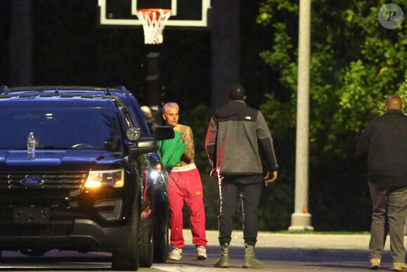 Exclusif - Justin Bieber enlève son sweatshirt et admire sa nouvelle couleur de cheveux rose dans le rétroviseur de sa jeep à Beverly Hills, Los Angeles. Le chanteur est allé jouer au basket avec des amis à la tombée de la nuit ! Le 24 novembre 2019.