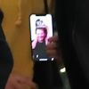 Exclusif - Joy Hallyday avec une photo de son père en fond d'écran sur son téléphone portable - Laeticia Hallyday, son compagnon et toute la famille arrivent à l'aéroport de Paris-Orly après avoir passé des vacances et le nouvel An à Marrakech au Maroc, à Orly, France, le 3 janvier 2020.