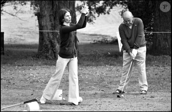 Archives - Bernard Blier et Mme Chaban Delmas jouent au golf. 1975.