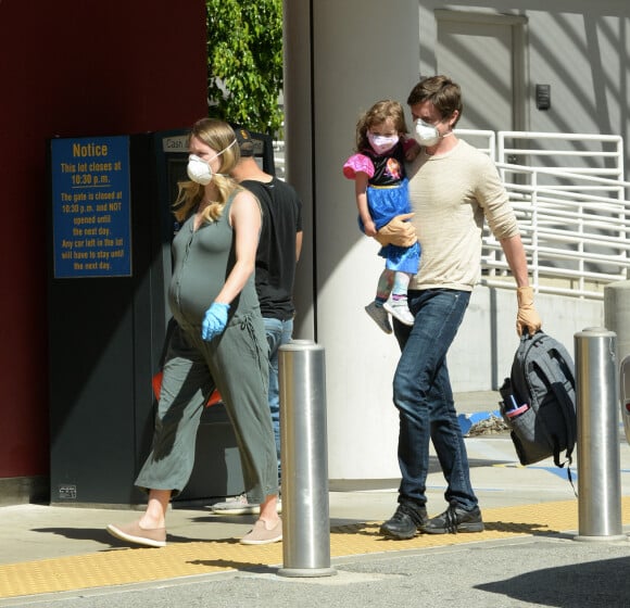 Exclusif - Topher Grace avec sa femme Ashley Hinshaw, enceinte, et leur fille Mabel, masqués en raison de l'épidémie de coronavirus (Covid-19), se promènent à Los Angeles, le 5 mai 2020.