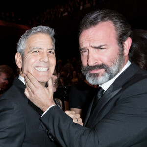 George Clooney retrouve son complice Jean Dujardin à la 42ème cérémonie des César à la salle Pleyel à Paris. © Olivier Borde / Dominique Jacovides / Bestimage