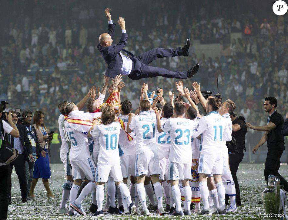 Les joueurs du Real Madrid et leur entraîneur Zinedine Zidane fêtent leur victoire en ligue des Champions à Madrid le 26 mai 2018.