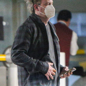 Exclusif - Matthew Perry, avec un masque de protection, à la sortie d'un centre médical accompagné d'un médecin à Los Angeles pendant l'épidémie de Coronavirus Covid-19 le 27 avril 2020. L'ex star de la série "Friends", qui avait dû rester alitée 3 mois en 2018 suite à une opération pour soigner une perforation gastro-intestinale , semble avoir encore quelques petits soucis à le voir se tenir le ventre.