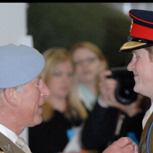 Le prince Harry reçoit une poignée de main de son père à l'occasion de la fin de sa formation de pilote d'hélicoptère militaire.