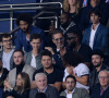 Ladj Ly, Kev Adams, Gims, Gad Elmaleh et son fils Noë assistent au match de football opposant le PSG à l'Olympique Lyonnais au Parc des Princes.