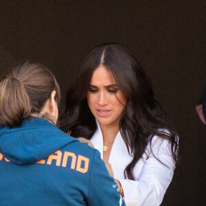 Meghan Markle prête son manteau à une athlète pour couvrir son bébé lors de la réception organisée par la ville de La Haye et le ministère néerlandais de la Défense, au Nations Home, la veille de l'ouverture des Invictus Games 2020 à Zuiderpark, La Haye, le 15 avril 2022. 