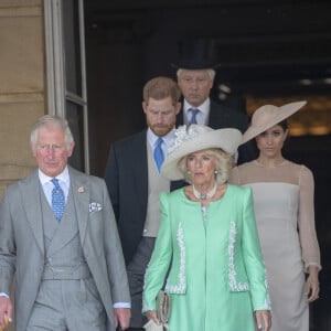 Camilla Parker Bowles, duchesse de Cornouailles, le prince Harry, duc de Sussex, et Meghan Markle, duchesse de Sussex, lors de la garden party pour les 70 ans du prince Charles au palais de Buckingham à Londres. Le 22 mai 2018 