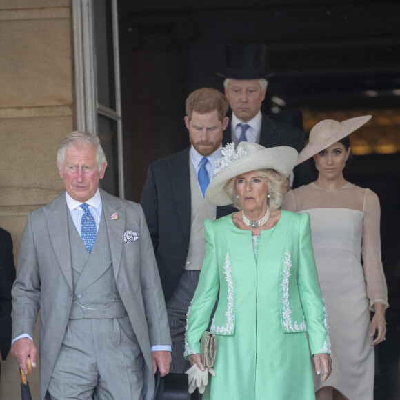 Camilla Parker Bowles, duchesse de Cornouailles, le prince Harry, duc de Sussex, et Meghan Markle, duchesse de Sussex, lors de la garden party pour les 70 ans du prince Charles au palais de Buckingham à Londres. Le 22 mai 2018 