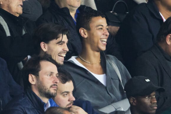 Guillaume Diop et Aurélien Gay - Tribunes lors du match de championnat de Ligue 1 Uber Eats opposant le Paris Saint-Germain (PSG) au RC Lens (3-1) au Parc des Princes à Paris le 15 avril 2023. © Cyril Moreau/Bestimage