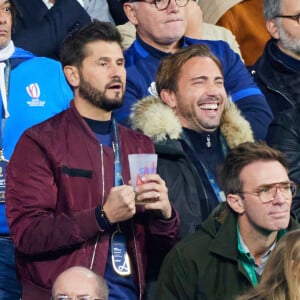 Christophe Beaugrand et son mari Ghislain Gerin - People des les tribunes de la coupe du Monde de Rugby France 2023 - Match de quart de finale "France-Afrique du Sud (28-29)" au Stade de France à Saint-Denis 15 octobre 2023. © Moreau-Jacovides/Bestimage 