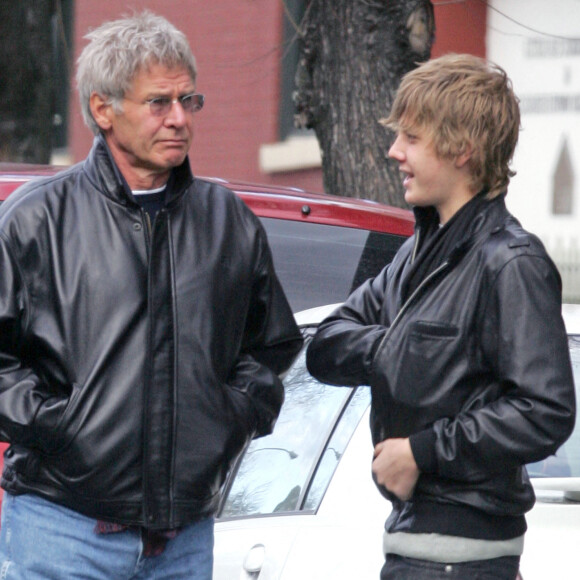 EXCLUSIVE. US actor Harrison Ford and his son Malcom are like father like son, wearing black leather jackets. They are outside Bar Piti where they had lunch. Malcom lits a cigarrette behind his famous father's back as they walked in search of a cab in New York, NY, USA, on March 15, 2006. Photo by Hector Vallenilla/ABACAPRESS.COM 