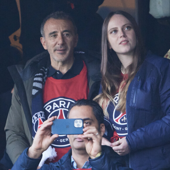 Elie Semoun et une amie - Célébrités dans les tribunes de la demi-finale retour de Ligue des champions entre le PSG face au Borussia Dortmund (0-1) au Parc des Princes à Paris le 7 mai 2024. © Cyril Moreau/Bestimage