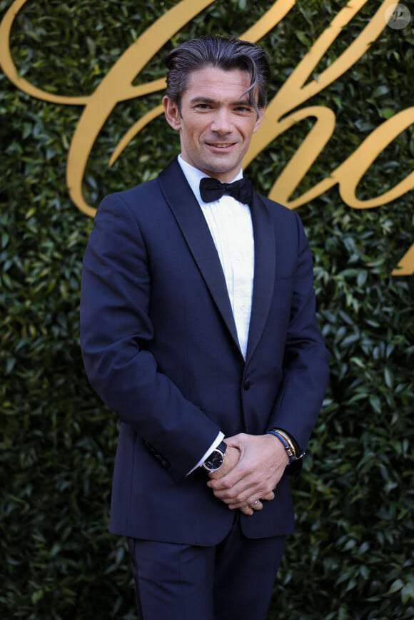 Sur la photographie, on découvre deux petites brunettes confortablement installées dans le sable et câlinées par leur papa. 
Gautier Capuçon - Photocall de la soirée Chopard "Once Upon A Time" à l'Eden Roc lors du 77ème Festival International du Film de Cannes.