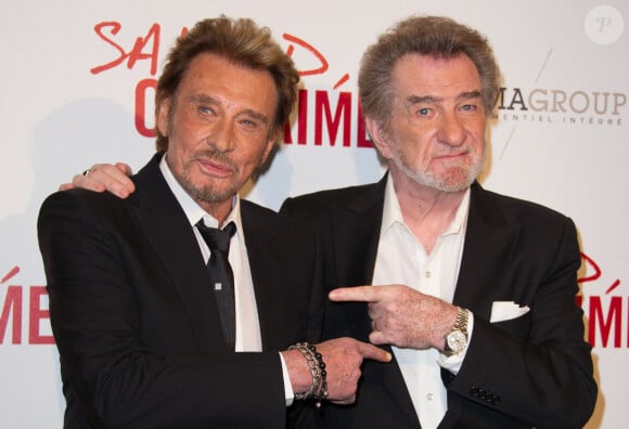 Il a perdu en 2017 l'un de ses meilleurs amis, Johnny Hallyday...
Johnny Hallyday et Eddy Mitchell assistent à l'avant-première de Salaud On T'Aime au cinéma UGC Normandie à Paris, France, le 31 mars 2014.