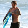 David Beckham, super papa avec ses enfants pour une séance de body-board sur la plage de Malibu le 18 juillet 2011, quelques semaines après la naissance de sa fille Seven Harper.