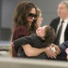 Victoria Beckham et Harper à leur arrivée à l'aéroport de New York, le 7 février 2012.