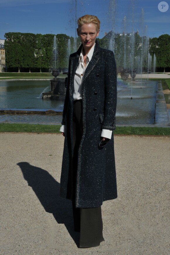 Tilda Swinton assiste au défilé Chanel qui présente sa collection Croisière 2012-2013 au château de Versailles. Le 14 mai 2012.