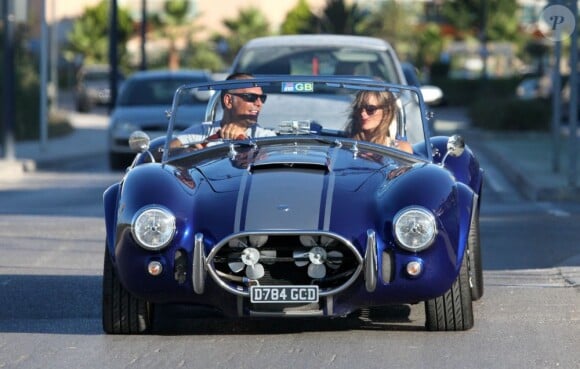 Christian Audigier et sa belle Nathalie Sorensen à bord d'un bolide de collection pour une promenade lors de leur escapade entre l'île de Formentera et Ibiza entre le 18 et le 22 juillet 2012