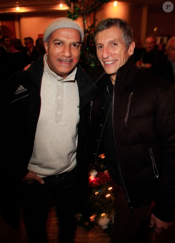 Nagui et Pascal Légitimus assistent à la soirée de lancement de l'opération les Pères Noel Verts à Paris le 3 décembre 2012.