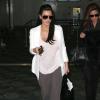 Kim Kardashian, enceinte, arrive à l'aéroport de Miami, le 6 janvier 2013. La star de la télé-réalité dévoile les premiers signes de sa grossesse.