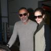 Christian Audigier et sa sublime fiancée Nathalie Sorensen arrivent à l'aéroport de Roissy CDG le 5 mars 2013.
