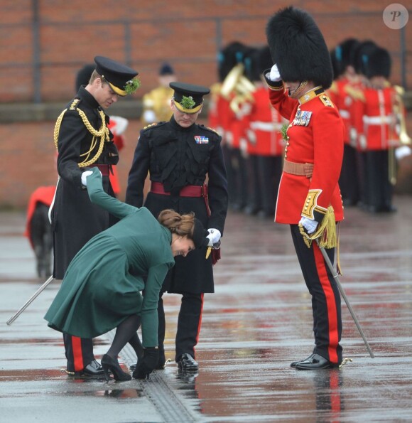La pauvre Kate Middleton (enceinte), duchesse de Cambridge, coince le talon de l'un de ses escarpins alors qu'elle assiste auprès du prince William à la parade de la St Patrick à Mons Barracks, Aldershot, le 17 mars 2013.